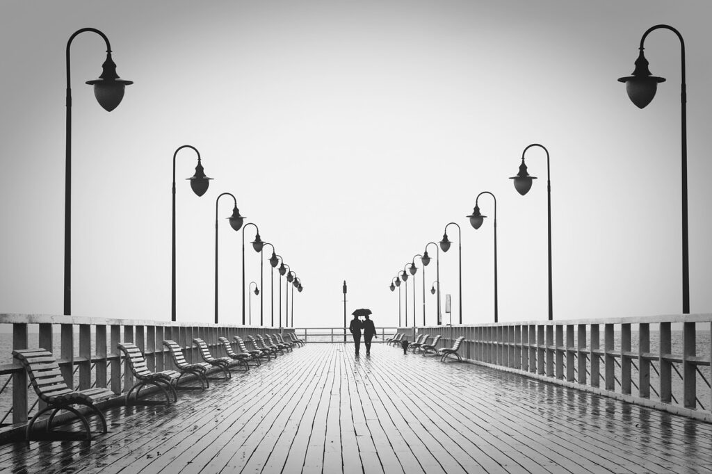 couple, boardwalk, silhouettes, walk, walking, pier, umbrella, rain, raining, together, walking together, jetty, nature, man, woman, people, leisure, romantic, relationship, romantic couple, monochrome, black and white